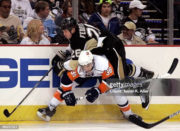 Jack Hillen of the New York Islanders hip checks Ruslan Fedotenko of the Pittsburgh Penguins in the third period at Mellon Arena on April 8, 2010 in...