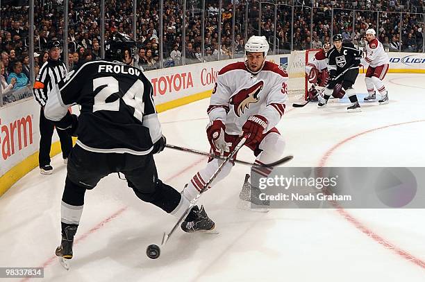 Alexander Frolov of the Los Angeles Kings battles for the puck against Adrian Aucoin of the Phoenix Coyotes on April 8, 2010 at Staples Center in Los...