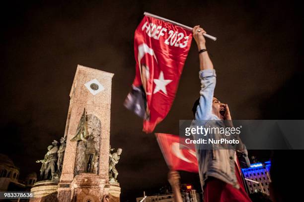 Supporters of Recep Tayyip Erdogan, candidate of the Justice and Development Party, celebrate his victory in presidential elections in Taksim square,...