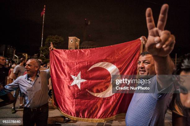 Supporters of Recep Tayyip Erdogan, candidate of the Justice and Development Party, celebrate his victory in presidential elections in Taksim square,...