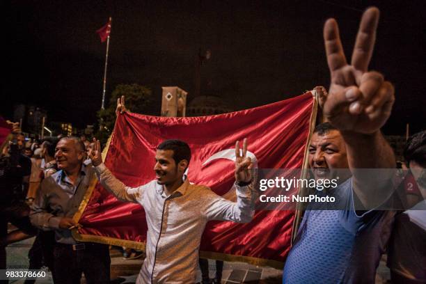 Supporters of Recep Tayyip Erdogan, candidate of the Justice and Development Party, celebrate his victory in presidential elections in Taksim square,...