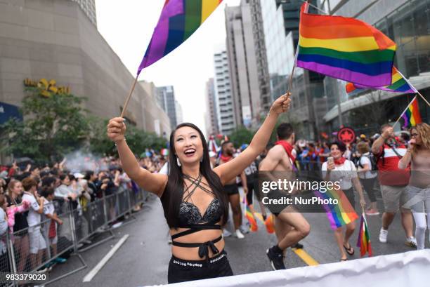 People lined the sidewalks along Yonge Street to witness the Annual Pride Parade on a rainy and wet day in Toronto, Canada, on June 24, 2018