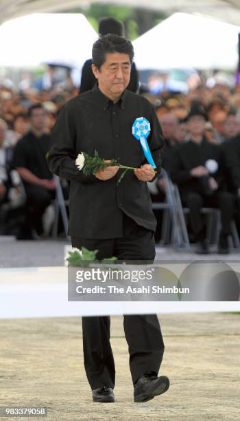 Prime Minister Shinzo Abe offers a flower at an altar during the memorial ceremony to mark the 73rd anniversary of the end of the Battle of Okinawa...