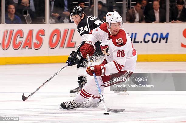 Wojtek Wolski of the Phoenix Coyotes skates with the puck against Alexander Frolov of the Los Angeles Kings on April 8, 2010 at Staples Center in Los...