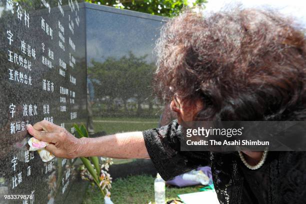 Year-old Sono Kuniyoshi sheds tears with touching the name of her younger sister at the Cornerstone of Peace where the names of their bereaved family...