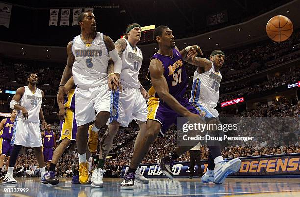 Ron Artest of the Los Angeles Lakers and Carmelo Anthony of the Denver Nuggets battle for a loose ball as J.R. Smith and Chris Andersen of the...