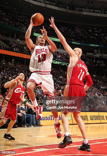 Joakim Noah of the Chicago Bulls shoots over Zydrunas Ilgauskas of the Cleveland Cavaliers on April 8, 2010 at the United Center in Chicago,...