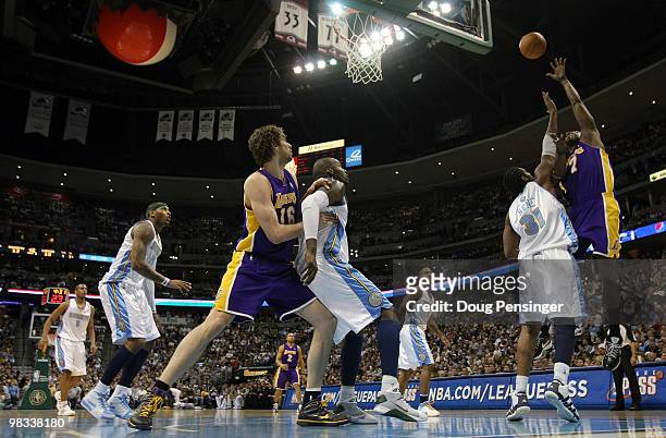 Lamar Odom of the Los Angeles Lakers takes a shot over Nene of the Denver Nuggets as Pau Gasol of the Lakers and Johan Petro of the Nuggets vie for...