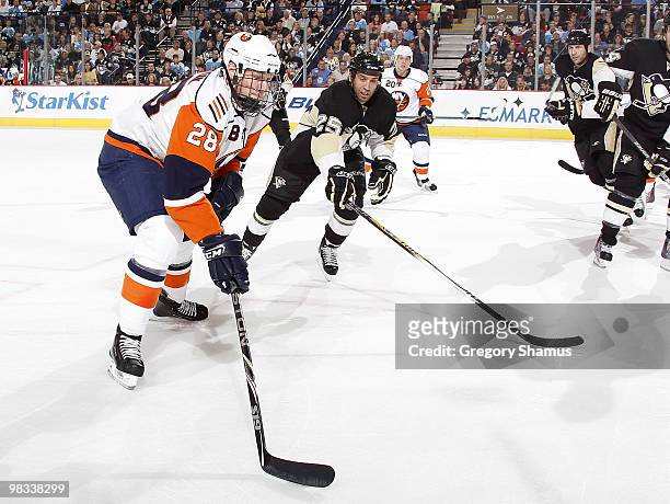 Tim Jackman of the New York Islanders controls the puck in front of Maxime Talbot of the Pittsburgh Penguins on April 8, 2010 at Mellon Arena in...