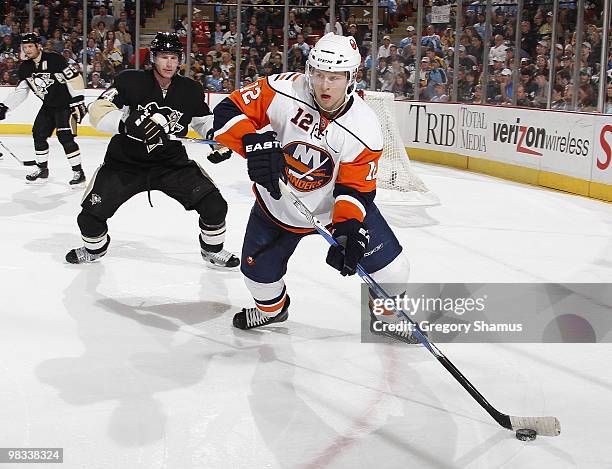 Josh Bailey of the New York Islanders moves the puck in front of Jordan Leopold of the Pittsburgh Penguins on April 8, 2010 at Mellon Arena in...