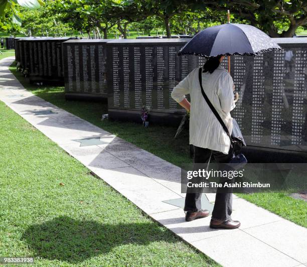 Woman visits the Cornerstone of Peace where the names of their bereaved family members and relatives engraved at the Peace Memorial Park on the 73rd...