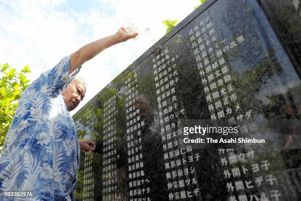 Man visits the Cornerstone of Peace where the names of their bereaved family members and relatives engraved at the Peace Memorial Park on the 73rd...