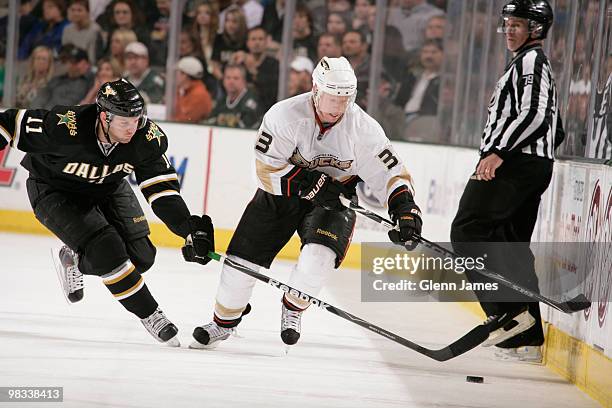 Jason Blake of the Anaheim Ducks handles the puck against Aaron Gagnon of the Dallas Stars on April 8, 2010 at the American Airlines Center in...