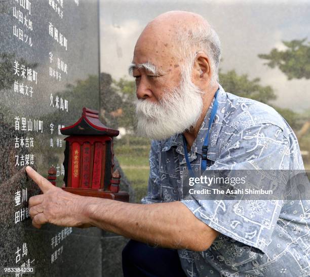 Year-old Eiichi Matayoshi prays for his younger brother at the Cornerstone of Peace where the names of their bereaved family members and relatives...