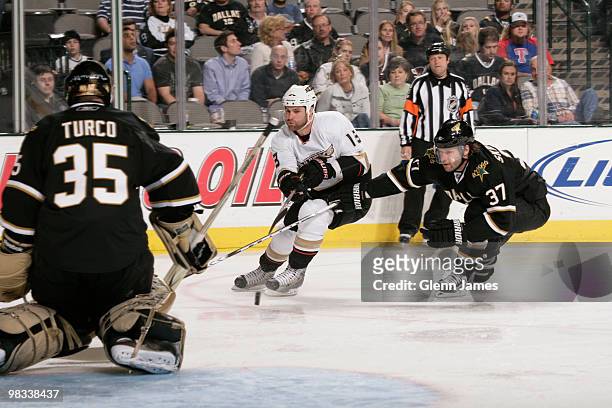 Mike Brown of the Anaheim Ducks moves the puck against Karlis Skrastins and Marty Turco of the Dallas Stars on April 8, 2010 at the American Airlines...