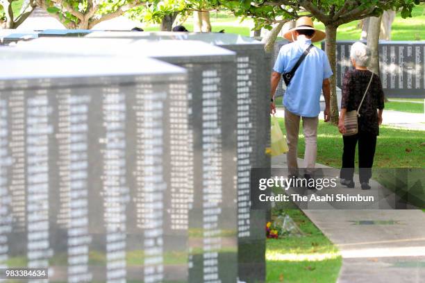 People pray for the victims at the Cornerstone of Peace where the names of their bereaved family members and relatives engraved at the Peace Memorial...