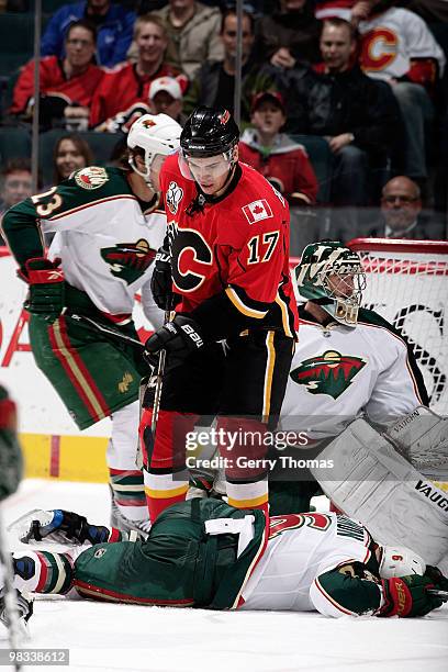 Greg Zanon of the Minnesota Wild lies on the ice after blocking a shot as Rene Bourque of the Calgary Flames looks for the puck on April 8, 2010 at...