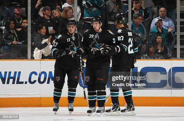 Torrey Mitchell, Logan Couture and Manny Malhotra of the San Jose Sharks celebrate a goal against the Vancouver Canucks during an NHL game on April...