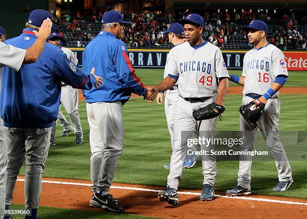 Carlos Marmol of the Chicago Cubs celebrates with manager Lou Piniella after the game against the Atlanta Braves at Turner Field on April 8, 2010 in...