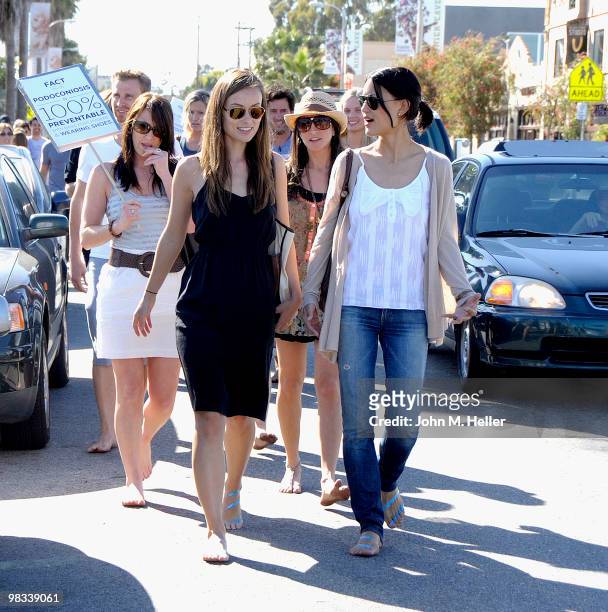Actors Olivia Wilde and Julia Jones attend the Toms Shoes Barefoot Walk For One Day Without Shoes on April 8, 2010 in Venice, California.
