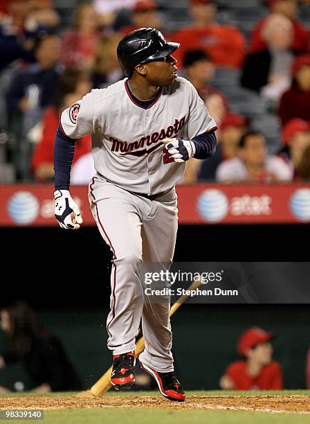 Delmon Young of the Minnesota Twins runs to first as he watches his three run home run in the ninth inning against the Los Angeles Angels of Anaheim...