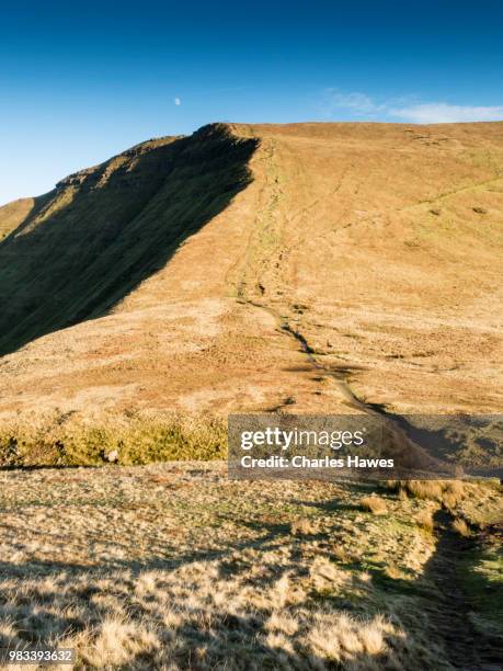 moon in sky above footpath from fan y big. image from a circular walk taking in the peaks of corn du and pen y fan in the brecon beacons national park, south wales, uk. january - pen y fan stock pictures, royalty-free photos & images