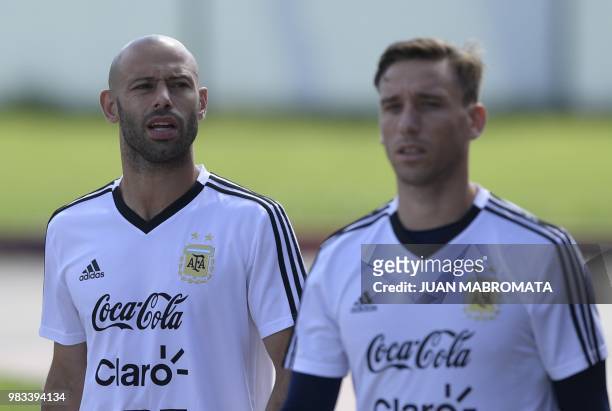 Argentina's midfielder Javier Mascherano and midfielder Lucas Biglia arrive to take part in a training session at the team's base camp in Bronnitsy,...