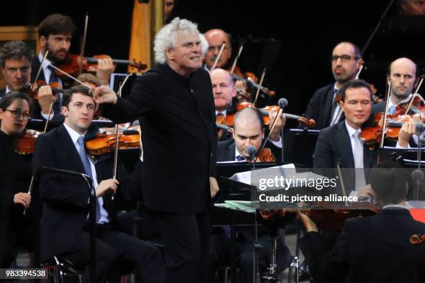 June 2018, Germany, Berlin: Sir Simon Rattle conducting during his last concert with the Berliner Philharmonie in the Waldbuehne. Rattle retired...