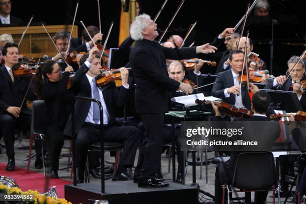 June 2018, Germany, Berlin: Sir Simon Rattle conducting during his last concert with the Berliner Philharmonie in the Waldbuehne. Rattle retired...