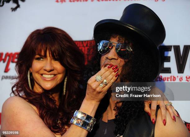 Perla Ferrar and musician Slash arrive at the 2nd annual Revolver Golden Gods Awards held at Club Nokia on April 8, 2010 in Los Angeles, California.