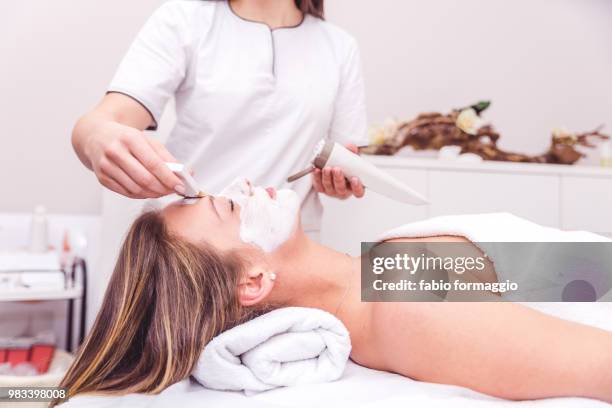 beautician apply skin mask - ear wax stock pictures, royalty-free photos & images