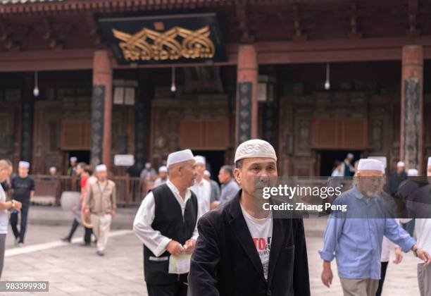 Muslim men seen in the square in front of the main hall of the Xi'an Great Mosque, many of them, from other cities such as Yinchuan or Xining, come...