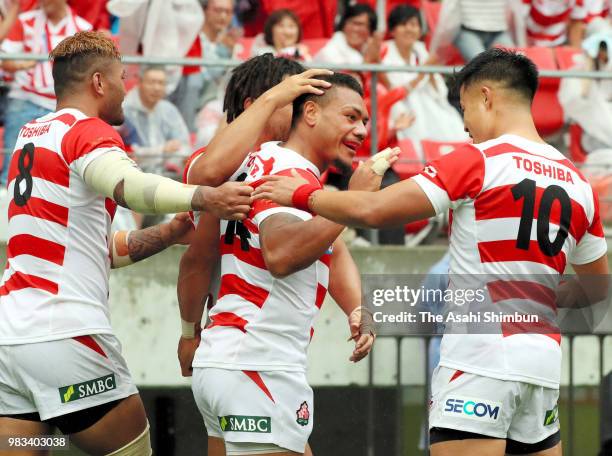 Lomano Lava Lemeki of Japan celebrates scoring his side's second try with his team mates during the rugby international match between Japan and...