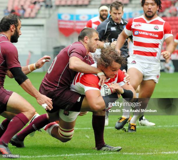 Wimpie van der Walt of Japan grounds the ball to score his side's first try during the rugby international match between Japan and Georgia at Toyota...