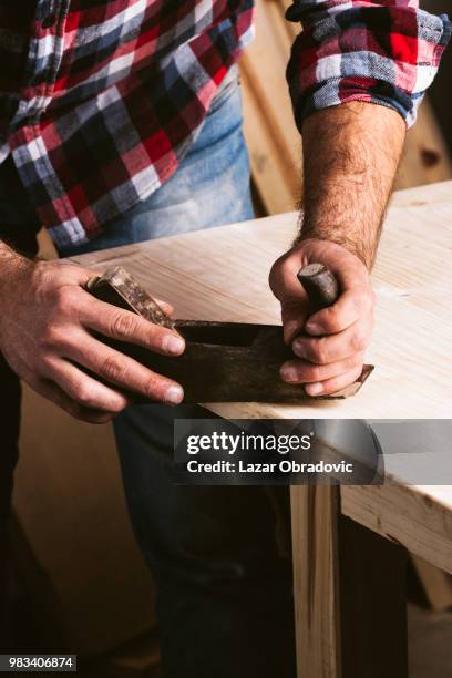 a carpenter holding tools. - obradovic stock pictures, royalty-free photos & images