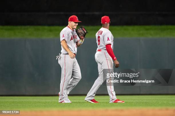 Mike Trout of the Los Angeles Angels laughs with Justin Upton against the Minnesota Twins on June 8, 2018 at Target Field in Minneapolis, Minnesota....
