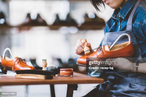 unrecognizable person brushing shoes - shoe polish stock pictures, royalty-free photos & images