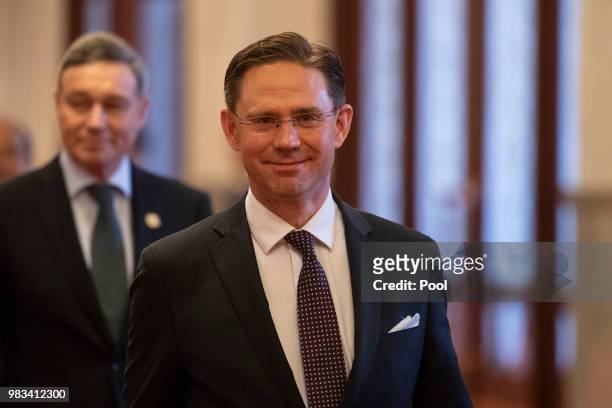 European Commission Vice President Jyrki Katainen arrives prior to a meeting with China's Premier Li Keqiang at the Great Hall of the People on June...