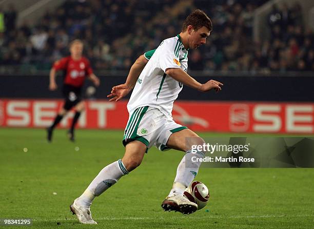 Edin Dzeko of Wolfsburg runs with the ball during the UEFA Europa League quarter final second leg match between VfL Wolfsburg and Fulham at...