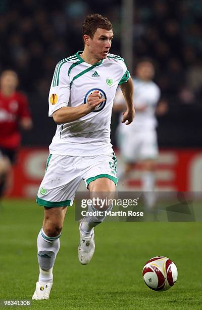 Edin Dzeko of Wolfsburg runs with the ball during the UEFA Europa League quarter final second leg match between VfL Wolfsburg and Fulham at...