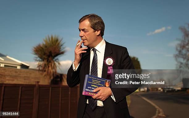 United Kingdom Independence Party member Nigel Farage takes a cigarette break as he campaigns on April 8, 2010 in Winslow, England. UKIP Member of...