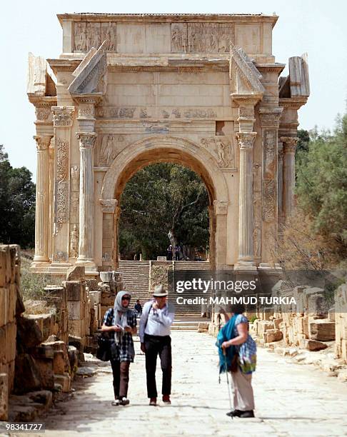 Tourists stand inside the entrance to the historical site of Leptis Magna, listed as a World Heritage Site, in the Libyan coastal city of Lebda on...