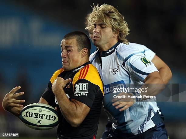 Richard Kahui of the Chiefs is hit hard by Wynand Olivier of the Bulls during the round nine Super 14 match between the Chiefs and the Bulls at...