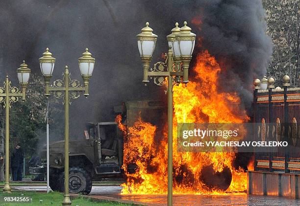 Kyrgyz riot policemen's car burns near the Government building in the capital Bishkek on April 7, 2010. Opposition followers killed Kyrgyzstan's...