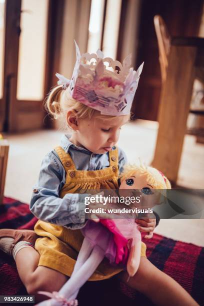 meisje, spelen met speelgoed pop in de speelkamer - doll house stockfoto's en -beelden