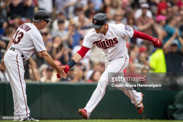 Logan Morrison of the Minnesota Twins celebrates with Gene Glynn against the Los Angeles Angels on June 10, 2018 at Target Field in Minneapolis,...