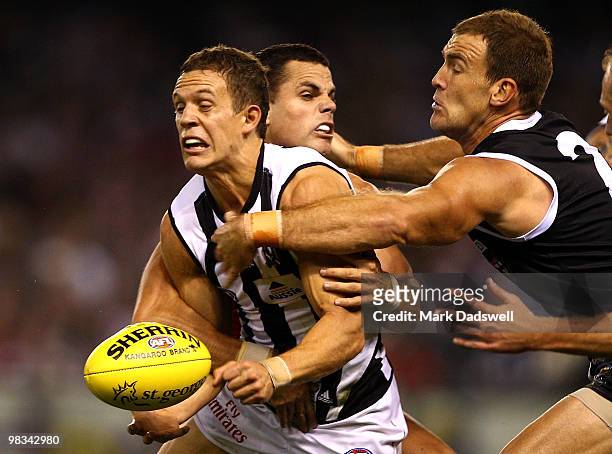 Luke Ball of the Magpies is tackled by Brett Peake and Steven King of the Saints during the round three AFL match between the St Kilda Saints and the...