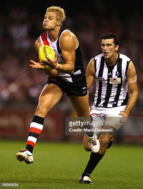 Nick Riewoldt of the Saints marks on the lead ahead of Simon Prestigiacomo of the Magpies during the round three AFL match between the St Kilda...