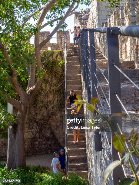 Tourists wander through the ruins of Tavira's 11th century castle. The Moorish- built town on the southern coast of Portugal is a popular tourist...