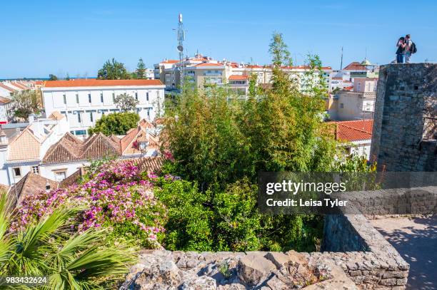 Tourists look out over Tavira from the town's 11th century castle. The Moorish- built town on the southern coast of Portugal is a popular tourist...